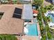 Aerial view of backyard with a swimming pool, hot tub, outdoor furniture, and solar panels at 8300 37Th N Ave, St Petersburg, FL 33710