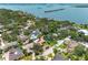 Aerial view of a neighborhood showcases tree coverage near the water at 8300 37Th N Ave, St Petersburg, FL 33710