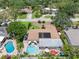 Aerial view showcases backyard pool and solar panels at 8300 37Th N Ave, St Petersburg, FL 33710