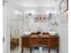 Elegant bathroom with double vessel sinks, wood vanity, and glass-enclosed shower at 8300 37Th N Ave, St Petersburg, FL 33710