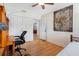 Bright bedroom with hardwood floors, ceiling fan, double closets, a tapestry, and an open doorway at 8300 37Th N Ave, St Petersburg, FL 33710