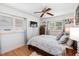 Comfortable bedroom featuring natural light, hardwood floors, ceiling fan, and a cozy bed at 8300 37Th N Ave, St Petersburg, FL 33710