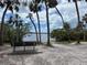 Enjoy the serene community waterfront view with seating, palm trees, and a calming atmosphere at 8300 37Th N Ave, St Petersburg, FL 33710