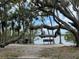 Scenic view of the community waterfront featuring mature shade trees and bench seating at 8300 37Th N Ave, St Petersburg, FL 33710