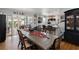 Bright dining room with a large table next to the open kitchen and outdoor seating area at 8300 37Th N Ave, St Petersburg, FL 33710
