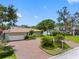 Charming single-story home features a brick driveway, two-car garage and a lush landscaped front yard at 8300 37Th N Ave, St Petersburg, FL 33710