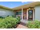Welcoming front porch with brick facade, a quaint seating area, and a well-maintained garden at 8300 37Th N Ave, St Petersburg, FL 33710