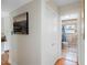 Hallway featuring a closet and an open doorway to a bathroom with tiled shower and neutral walls at 8300 37Th N Ave, St Petersburg, FL 33710
