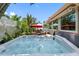Relaxing hot tub with a view of the patio, pool, and lush tropical landscaping at 8300 37Th N Ave, St Petersburg, FL 33710