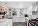 A sunlit kitchen features stainless steel appliances, a granite countertop, and bright white cabinets at 8300 37Th N Ave, St Petersburg, FL 33710