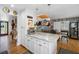 Modern kitchen island sits next to a dining room that has access to a bedroom in this home at 8300 37Th N Ave, St Petersburg, FL 33710