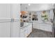 Bright, updated kitchen with white cabinets, granite countertops, and modern stainless steel appliances at 8300 37Th N Ave, St Petersburg, FL 33710