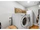 Convenient laundry room with washer, dryer, and wood floors at 8300 37Th N Ave, St Petersburg, FL 33710
