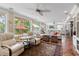 Open living area features travertine floors, a ceiling fan, and access to backyard at 8300 37Th N Ave, St Petersburg, FL 33710