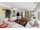 Bright living room features built-in shelving, travertine floors, and comfortable seating at 8300 37Th N Ave, St Petersburg, FL 33710