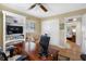Bright office space with built-in shelving, shutters, neutral walls, a ceiling fan, and hardwood floors at 8300 37Th N Ave, St Petersburg, FL 33710