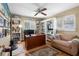 Spacious home office with custom built-ins, a ceiling fan, a desk, and a comfortable seating area at 8300 37Th N Ave, St Petersburg, FL 33710