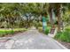 Paved trail leads through a lush park with mature trees, inviting visitors to enjoy the beauty of nature at 8300 37Th N Ave, St Petersburg, FL 33710