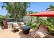 Relaxing patio features a hot tub, comfortable seating, and a cozy fire pit, all surrounded by lush greenery at 8300 37Th N Ave, St Petersburg, FL 33710