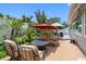Inviting backyard patio with a fire pit, lounge furniture, and lush tropical landscaping at 8300 37Th N Ave, St Petersburg, FL 33710