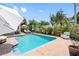 Enjoy this beautiful pool, complete with sun loungers and a white bench at 8300 37Th N Ave, St Petersburg, FL 33710