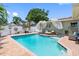 Beautiful in-ground pool features a brick surround and an inviting lounge area at 8300 37Th N Ave, St Petersburg, FL 33710