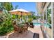 A comfortable patio area with umbrella-covered seating next to the pool at 8300 37Th N Ave, St Petersburg, FL 33710