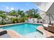 A sparkling pool and an outdoor entertaining area complete with lush landscaping at 8300 37Th N Ave, St Petersburg, FL 33710