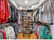 Spacious walk-in closet with custom shelving and ample storage for clothes and shoes at 8300 37Th N Ave, St Petersburg, FL 33710