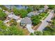 Aerial view of home showing proximity to lake, nearby houses, street, and surrounding trees at 921 Lynnlea Ln, Tarpon Springs, FL 34689