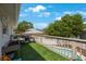 Upstairs balcony with barbecue area and view of neighborhood at 921 Lynnlea Ln, Tarpon Springs, FL 34689