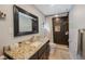 Modern bathroom with granite countertops, dark shower, and framed mirror offering a clean and stylish space at 921 Lynnlea Ln, Tarpon Springs, FL 34689