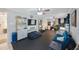 Large flex room with modern conveniences including a TV, compact fridge, and comfortable seating at 921 Lynnlea Ln, Tarpon Springs, FL 34689