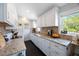 Bright kitchen with white cabinets, granite countertops, dark hardwood floors, and stainless steel appliances at 921 Lynnlea Ln, Tarpon Springs, FL 34689