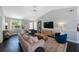 Neutral living room with hardwood floors, vaulted ceilings, and large windows for plenty of natural light at 921 Lynnlea Ln, Tarpon Springs, FL 34689