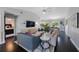 Spacious living room that opens to the dining area and kitchen and features dark hardwood floors at 921 Lynnlea Ln, Tarpon Springs, FL 34689