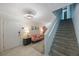 Cozy living area features a modern light fixture, vibrant artwork, and a staircase nearby the entrance at 921 Lynnlea Ln, Tarpon Springs, FL 34689