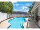 Backyard pool with unique curves features a concrete patio, perfect for outdoor relaxation and fun at 921 Lynnlea Ln, Tarpon Springs, FL 34689