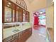 Bar area with display cabinets, granite countertop, and mirrored backsplash at 9460 Bearfoot Trl, Weeki Wachee, FL 34613