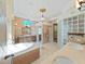 Elegant bathroom with a soaking tub, double sinks, and glass block window at 9460 Bearfoot Trl, Weeki Wachee, FL 34613