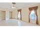 Bright, airy bedroom with decorative ceiling fan and large windows at 9460 Bearfoot Trl, Weeki Wachee, FL 34613
