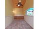 Unique bonus room features a custom ceiling fan, arched window, and built-in storage cabinets at 9460 Bearfoot Trl, Weeki Wachee, FL 34613