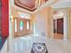 Grand foyer featuring a decorative ceiling, chandelier, and detailed woodwork at 9460 Bearfoot Trl, Weeki Wachee, FL 34613