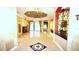 Spacious foyer with tile flooring, chandelier, and intricate architectural details at 9460 Bearfoot Trl, Weeki Wachee, FL 34613