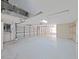 Spacious three-car garage with ample storage and lighting at 9460 Bearfoot Trl, Weeki Wachee, FL 34613
