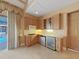 Cozy kitchen with gas cooktop, wine cooler, and access to the pool area at 9460 Bearfoot Trl, Weeki Wachee, FL 34613