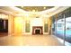 Cozy living room with fireplace, chandelier, and access to an outdoor pool area at 9460 Bearfoot Trl, Weeki Wachee, FL 34613
