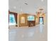 Spacious living room with fireplace, decorative ceiling fan and detailed trimwork throughout at 9460 Bearfoot Trl, Weeki Wachee, FL 34613