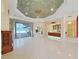 Grand living room with a decorative ceiling, chandelier, and sliding doors to the patio at 9460 Bearfoot Trl, Weeki Wachee, FL 34613