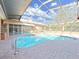 Inviting pool with a brick paved deck and enclosed screened ceiling at 9460 Bearfoot Trl, Weeki Wachee, FL 34613